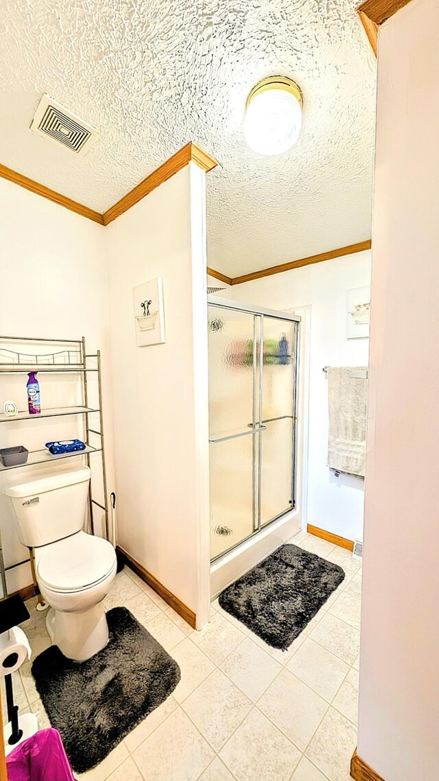 full bathroom with tile patterned floors, toilet, a stall shower, visible vents, and ornamental molding