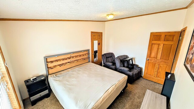 bedroom featuring carpet, a textured ceiling, and ornamental molding