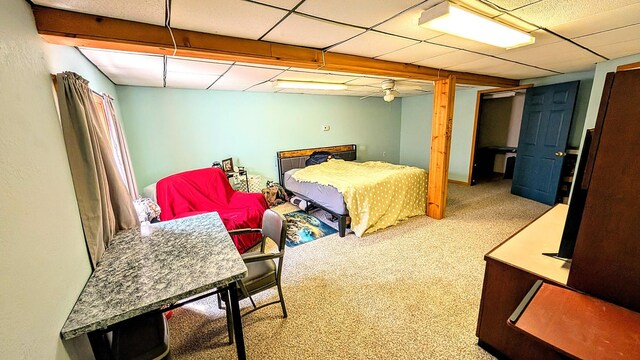 carpeted bedroom featuring a paneled ceiling