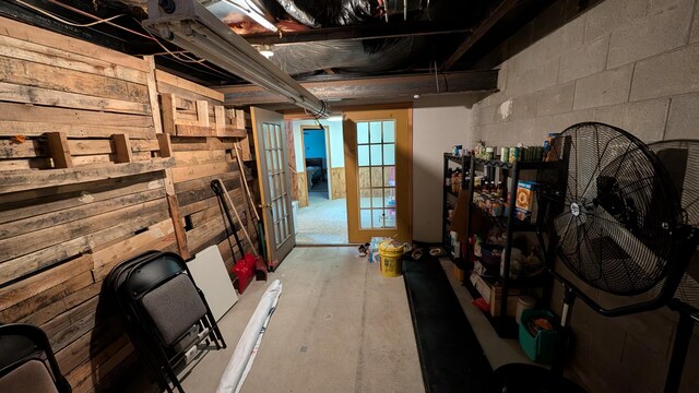 basement featuring concrete block wall and wooden walls