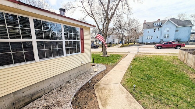 view of yard featuring fence and a residential view