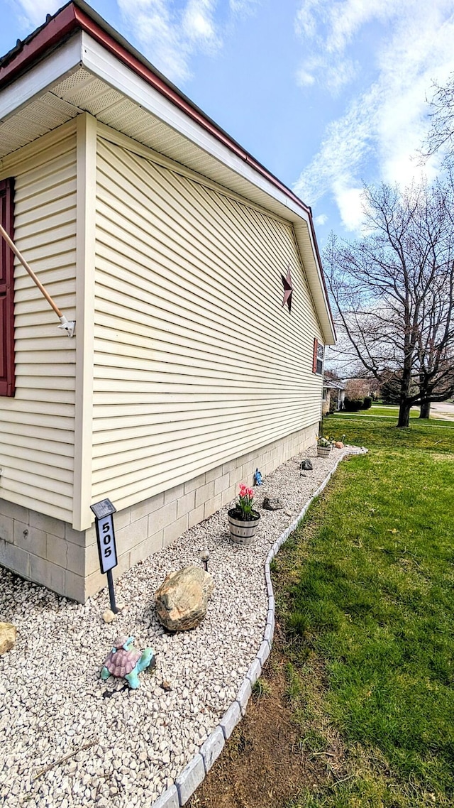 view of property exterior with a yard