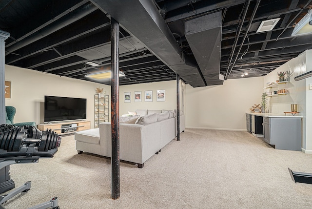 living area featuring bar area, baseboards, light carpet, and visible vents