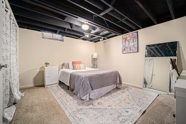 bedroom with baseboards and carpet