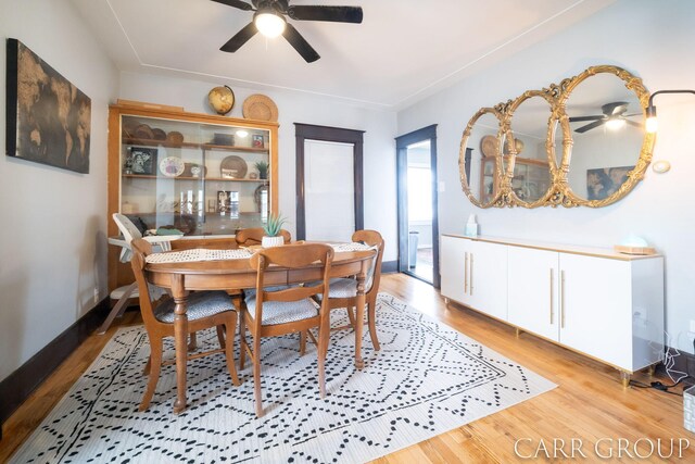 dining room with light wood-style flooring and a ceiling fan