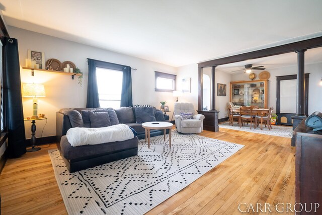 living room with light wood finished floors and ceiling fan