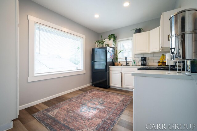 kitchen featuring white cabinets, recessed lighting, light countertops, and freestanding refrigerator