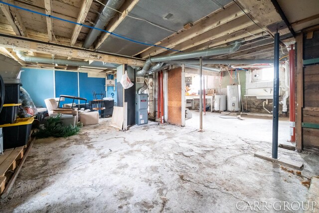 below grade area with heating unit and electric water heater