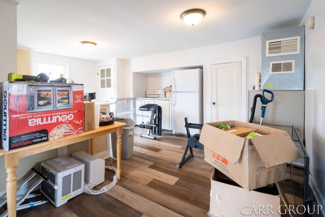 dining space featuring visible vents and wood finished floors