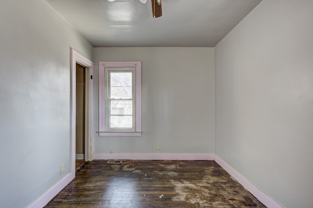 unfurnished room featuring baseboards, visible vents, and hardwood / wood-style flooring