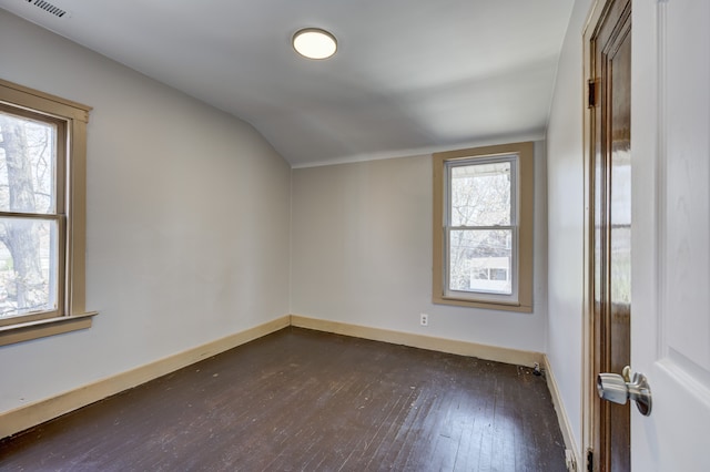 bonus room with baseboards, vaulted ceiling, dark wood-style flooring, and visible vents