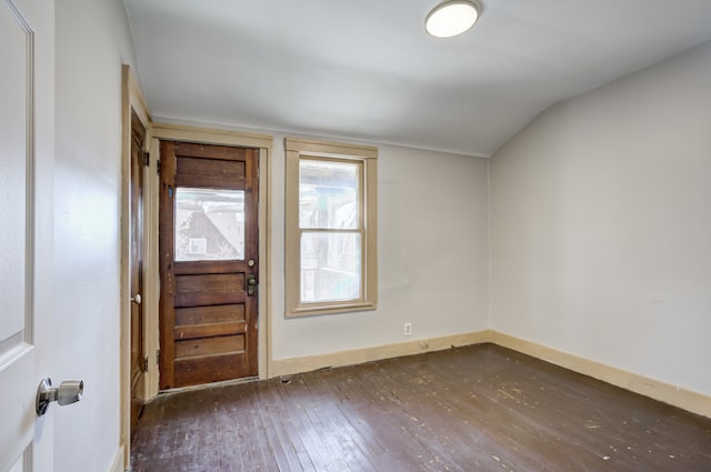 foyer with baseboards, lofted ceiling, and hardwood / wood-style flooring