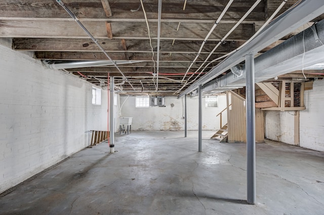 basement with a sink and stairway