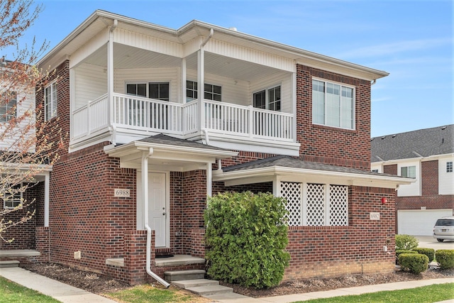 view of front of property featuring brick siding and a balcony