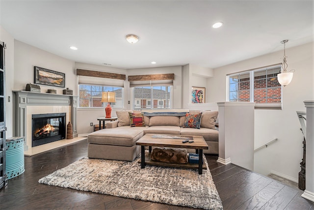 living area with recessed lighting, baseboards, dark wood finished floors, and a fireplace