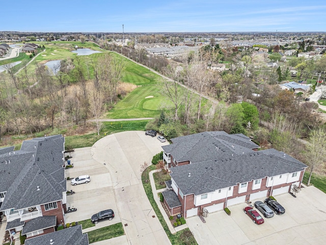 bird's eye view with a water view, view of golf course, and a residential view