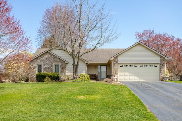 ranch-style house featuring a garage, brick siding, a front yard, and aphalt driveway