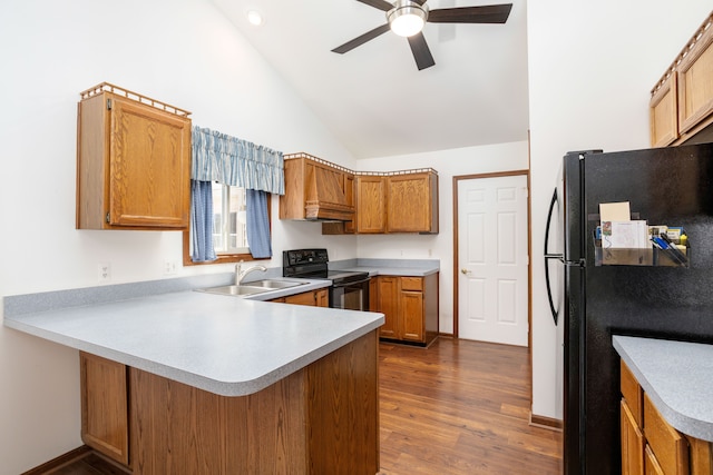 kitchen with a sink, ceiling fan, black appliances, a peninsula, and light countertops