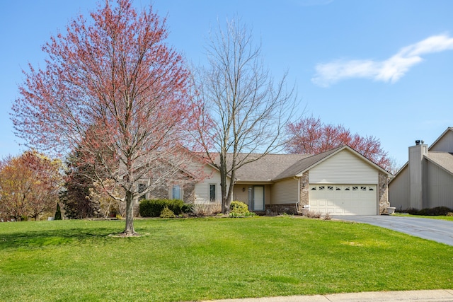 ranch-style house featuring a garage, driveway, a front lawn, and brick siding