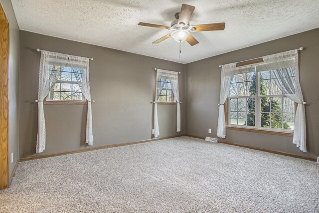 17026 H Dr S, Marshall, MI 49068 - unfurnished room featuring a textured ceiling, visible vents, a ceiling fan, and baseboards