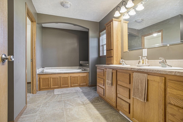 17026 H Dr S, Marshall, MI 49068 - bathroom with double vanity, a bath, a textured ceiling, and a sink