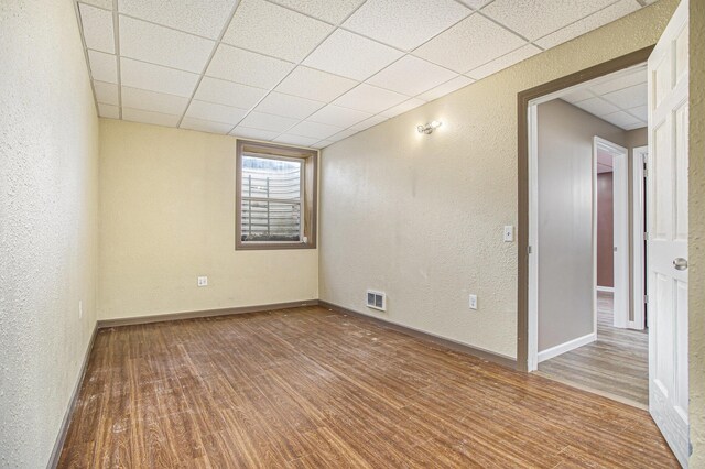 17026 H Dr S, Marshall, MI 49068 - unfurnished room featuring wood finished floors, visible vents, and a textured wall