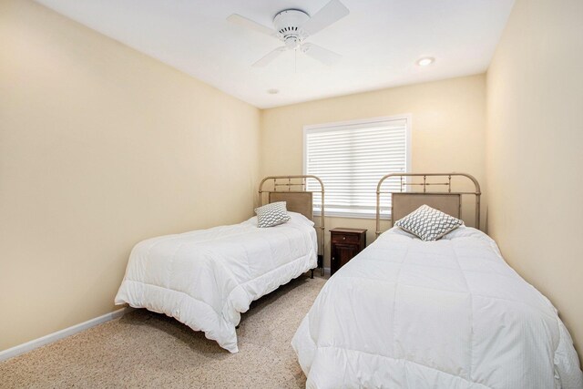 carpeted bedroom featuring a ceiling fan and baseboards