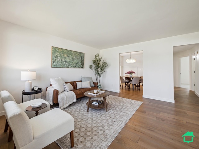 living area with wood finished floors and baseboards