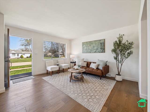 living room with hardwood / wood-style flooring and baseboards