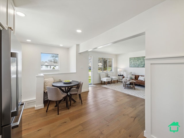 dining area featuring baseboards, light wood-type flooring, and recessed lighting