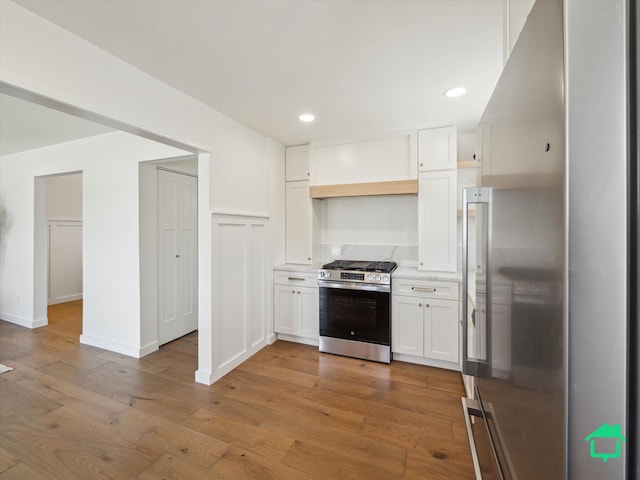 kitchen with recessed lighting, open shelves, light wood-style flooring, white cabinets, and appliances with stainless steel finishes