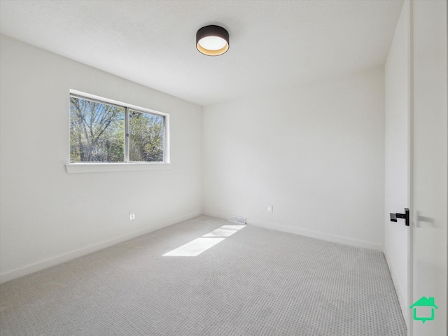 unfurnished room featuring carpet flooring and baseboards