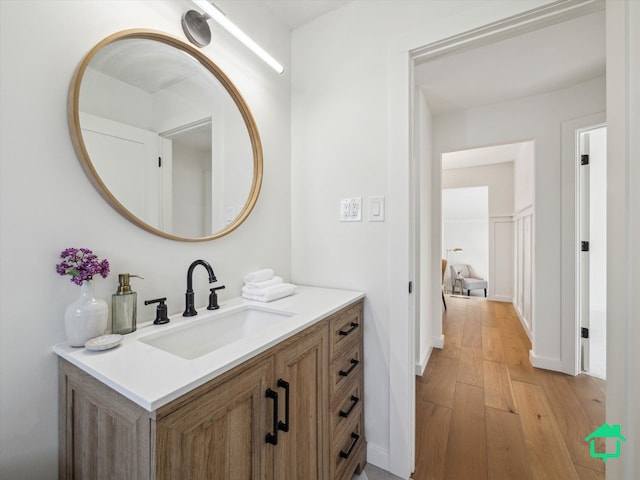 bathroom with vanity and wood finished floors