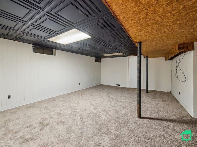 finished basement with carpet flooring and an ornate ceiling