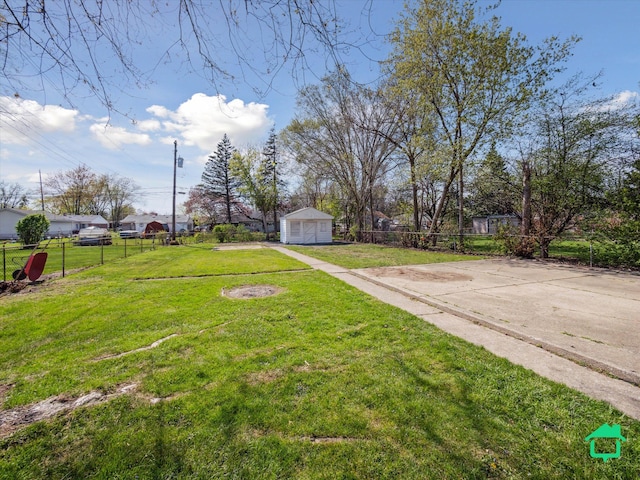 view of yard with fence and a garage