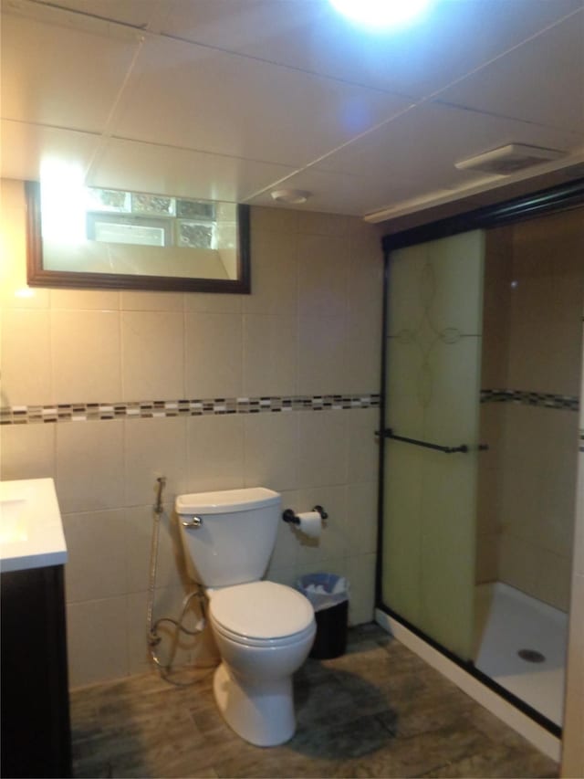 1353 N Gulley Rd, Dearborn Heights, MI 48127 - full bathroom featuring toilet, tile walls, visible vents, a shower stall, and vanity