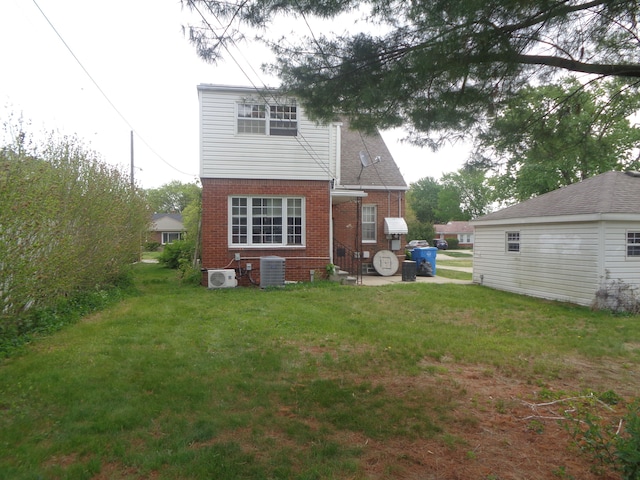 1353 N Gulley Rd, Dearborn Heights, MI 48127 - back of property with a lawn, central AC unit, and brick siding