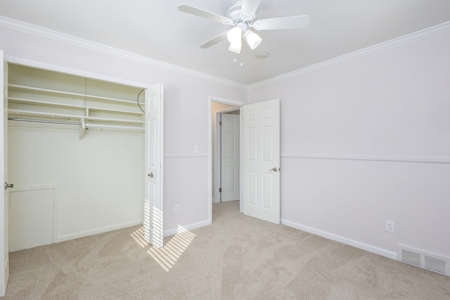 unfurnished bedroom with crown molding, visible vents, carpet floors, and baseboards