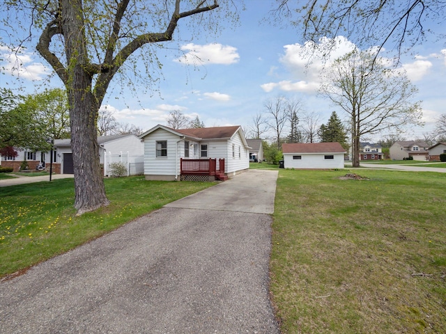 view of front facade with a front lawn and aphalt driveway