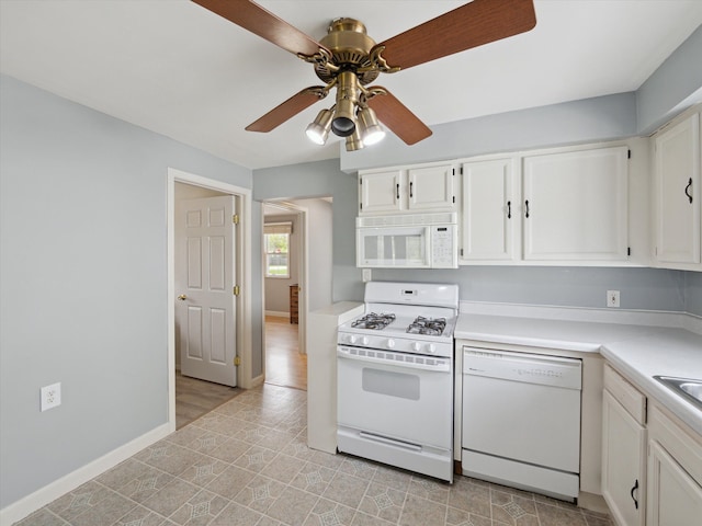 kitchen with white appliances, baseboards, light countertops, white cabinetry, and a ceiling fan