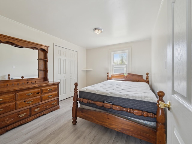 bedroom with light wood-type flooring and a closet
