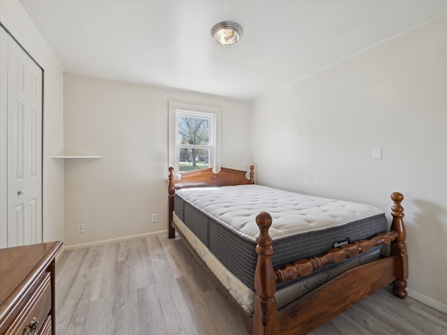 bedroom with baseboards and wood finished floors
