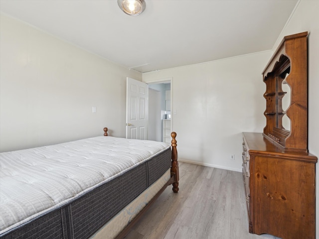 bedroom with baseboards and light wood-style flooring