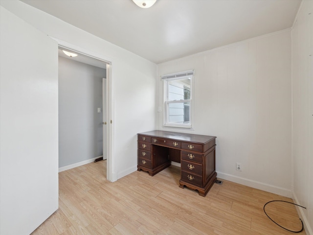 unfurnished office featuring baseboards and light wood finished floors