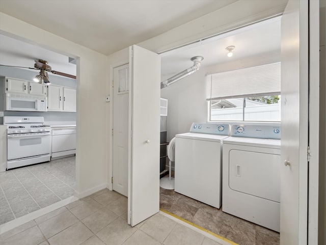 washroom featuring laundry area, washing machine and dryer, baseboards, a ceiling fan, and light tile patterned floors