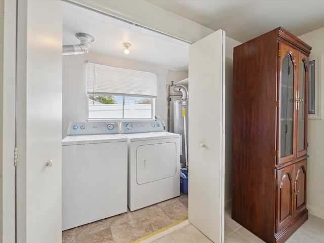 laundry room with water heater, laundry area, and washing machine and dryer