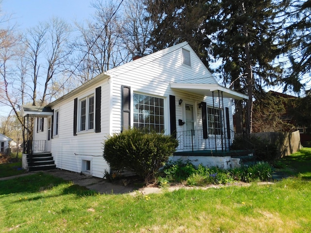 bungalow-style house featuring a porch and a front yard