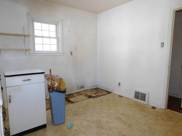 spare room featuring light floors and visible vents