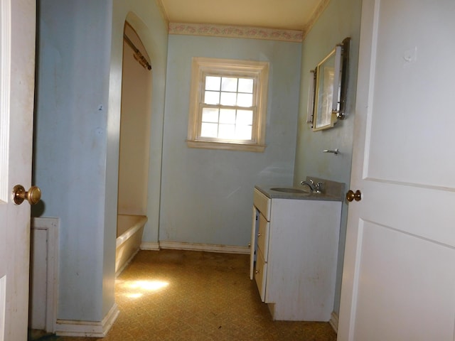 full bathroom featuring a bath, vanity, and tile patterned floors