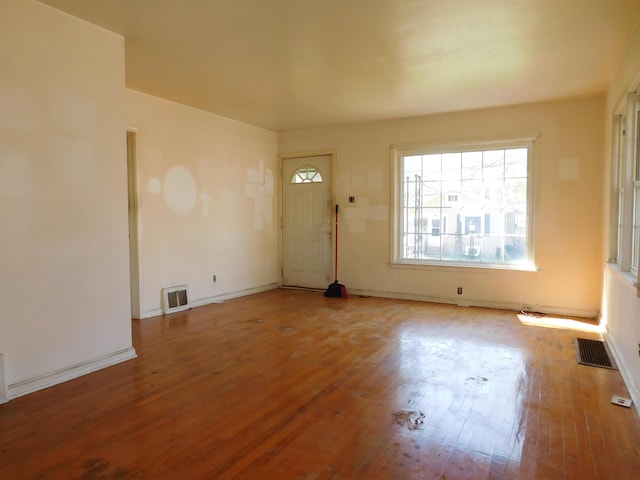 entrance foyer featuring wood finished floors, visible vents, and baseboards